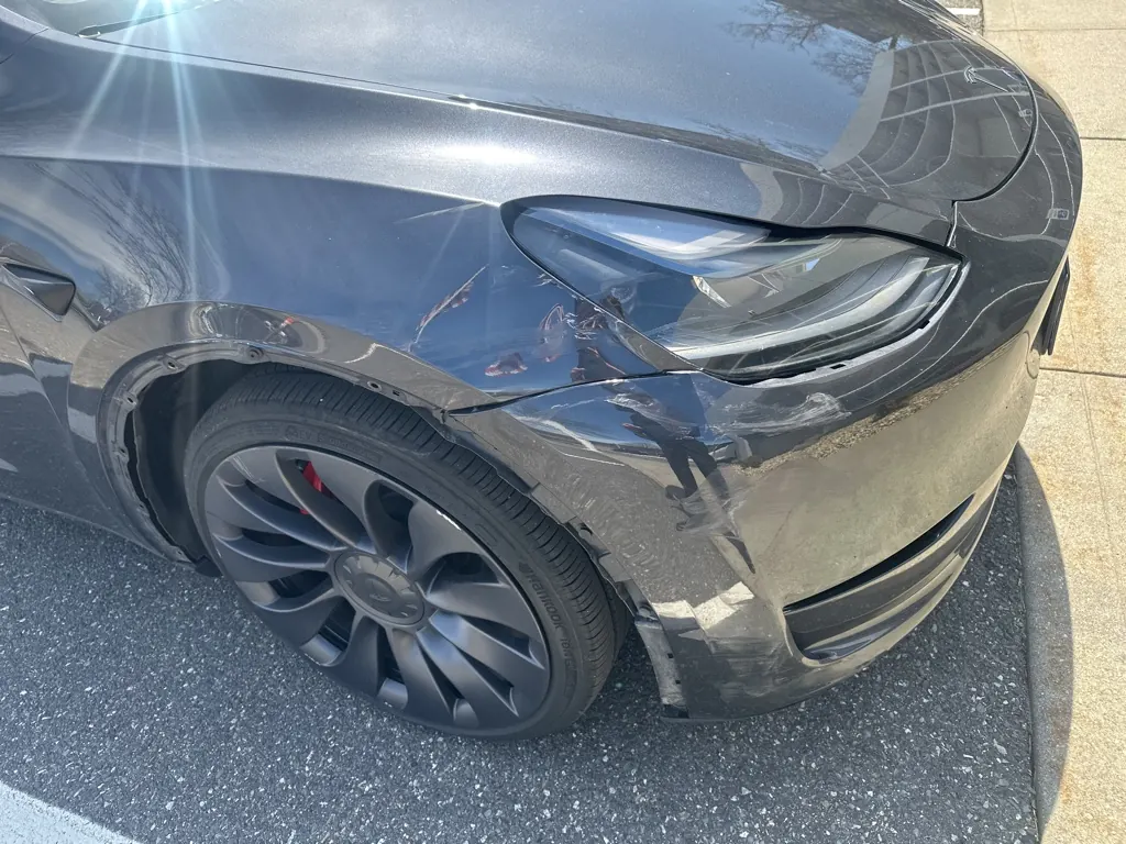 Tesla with front-end collision damage brought in for repair in Worcester, MA