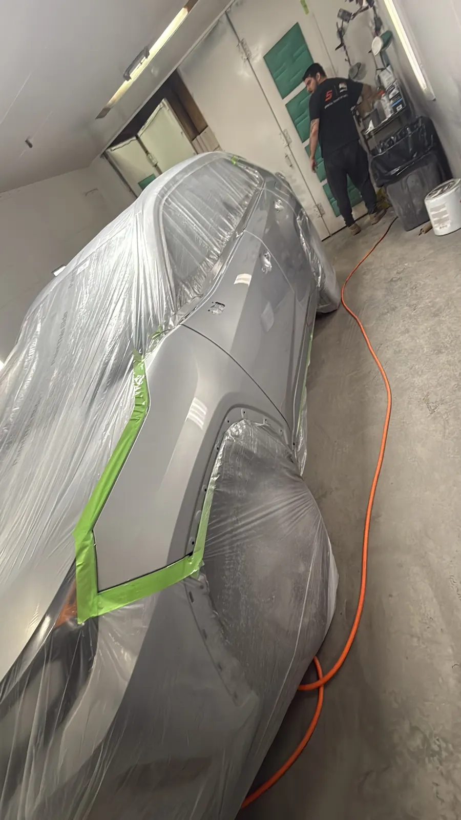 Vehicle inside the spray booth during refinishing at Best Finish Auto Body