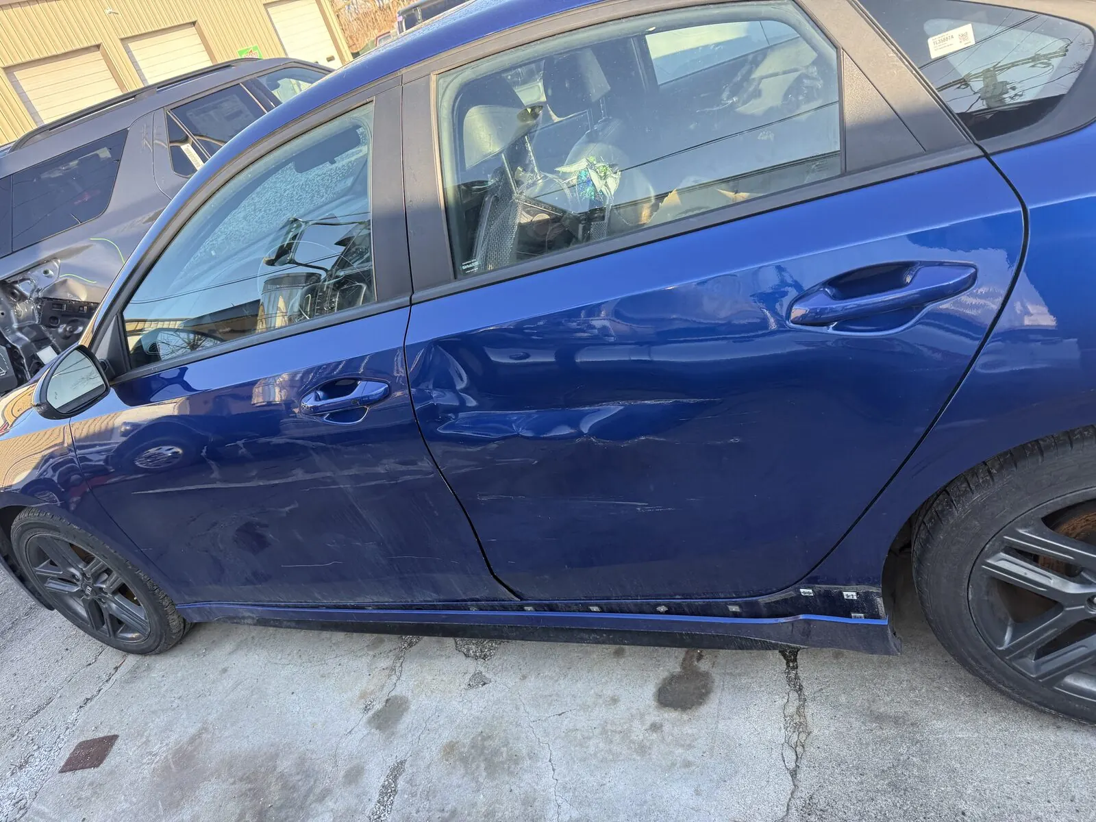 Close view of a repaired and repainted rear panel with matched color